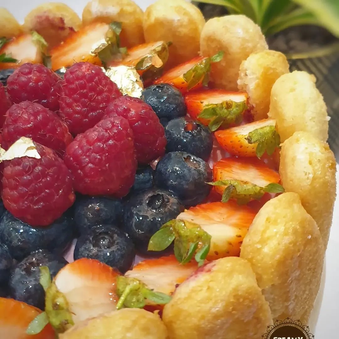 Fresh raspberries, blueberries and strawberries crowning a Berries Charlotte