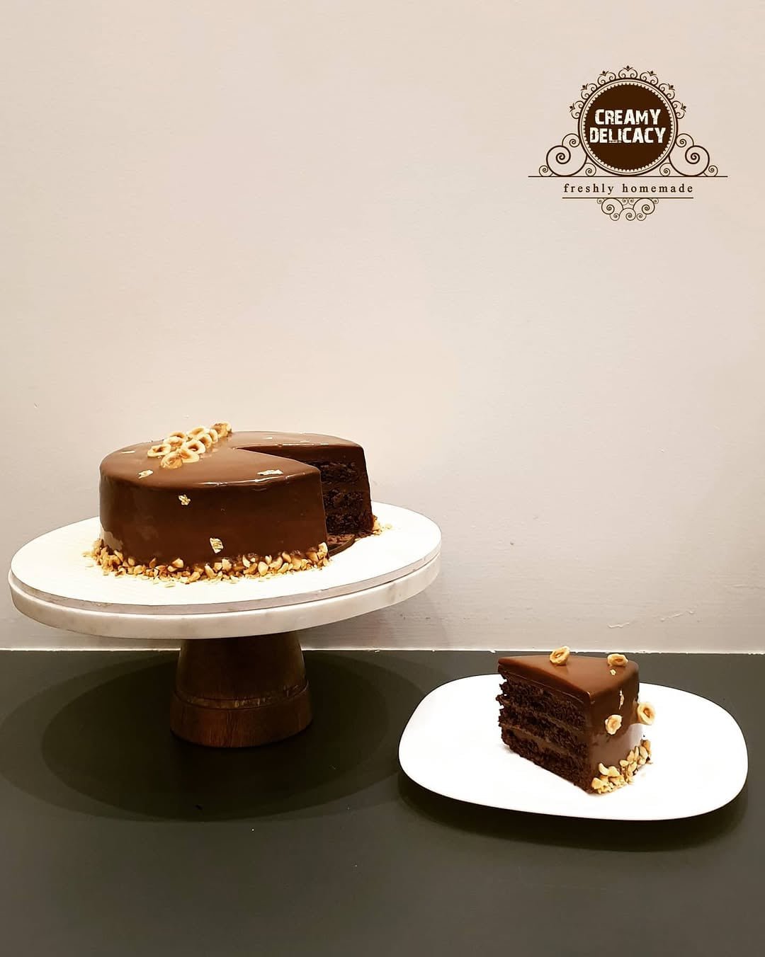 Hazelnut and chocolate gateau with a slice cut