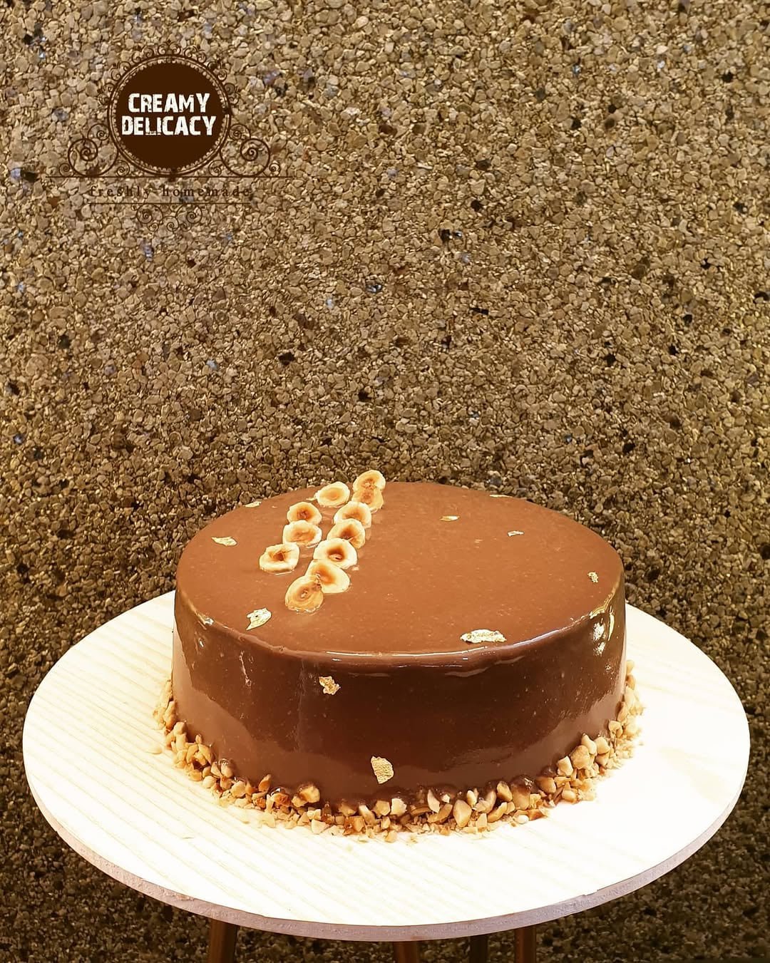 Glossy hazelnut and chocolate gateau with roasted hazelnuts